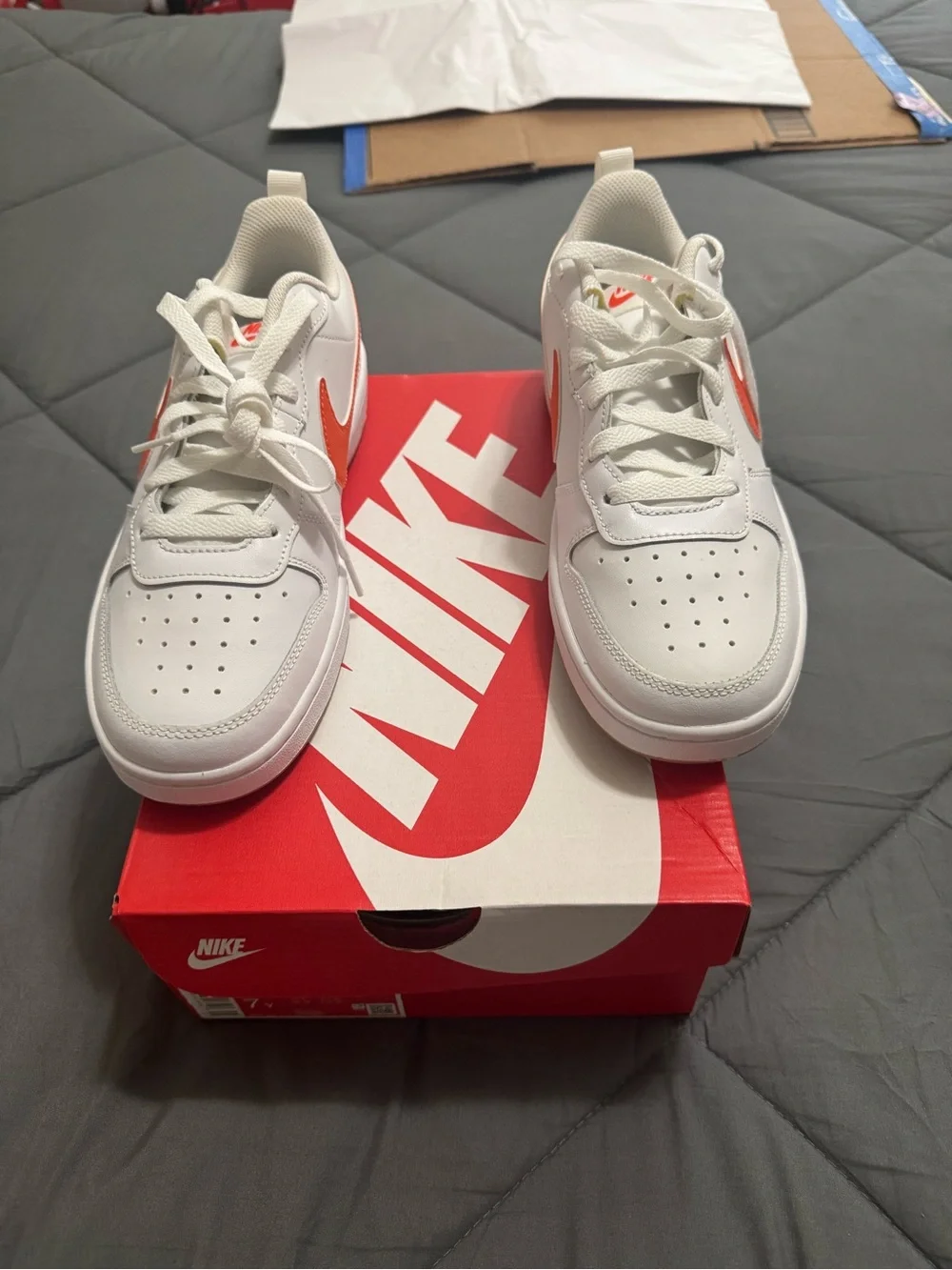 Nike Kids White Sneakers with Orange Swoosh Accent